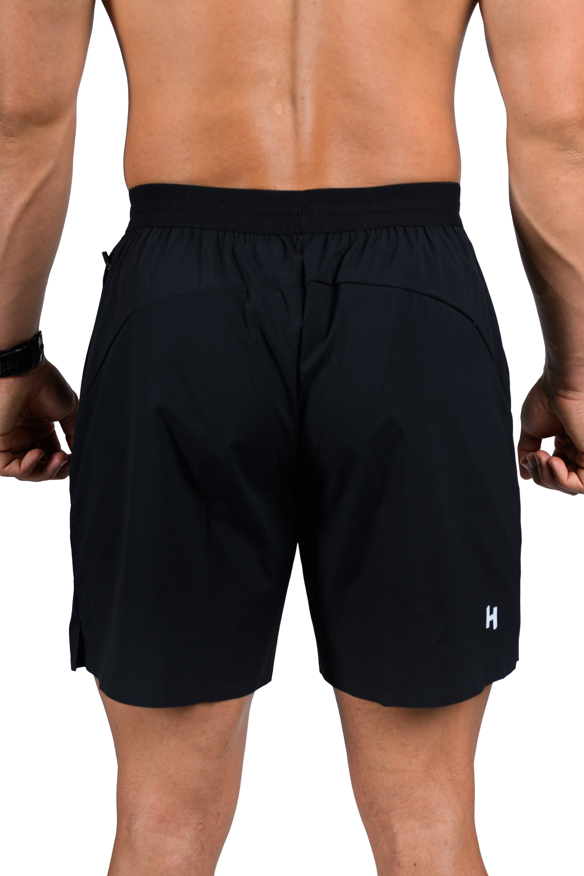 Person wearing black shorts on a white background