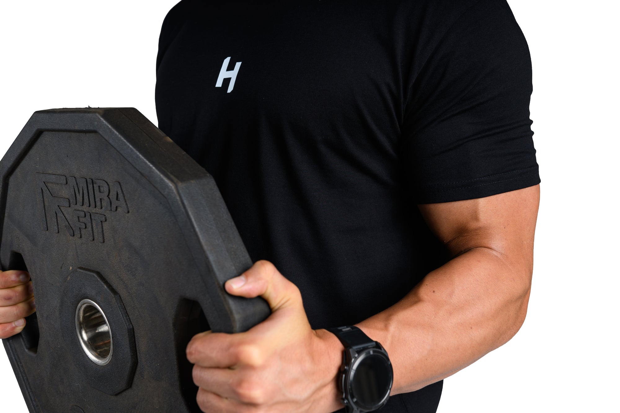 Person holding a black weight plate with 'Mira Fit' branding on a white background