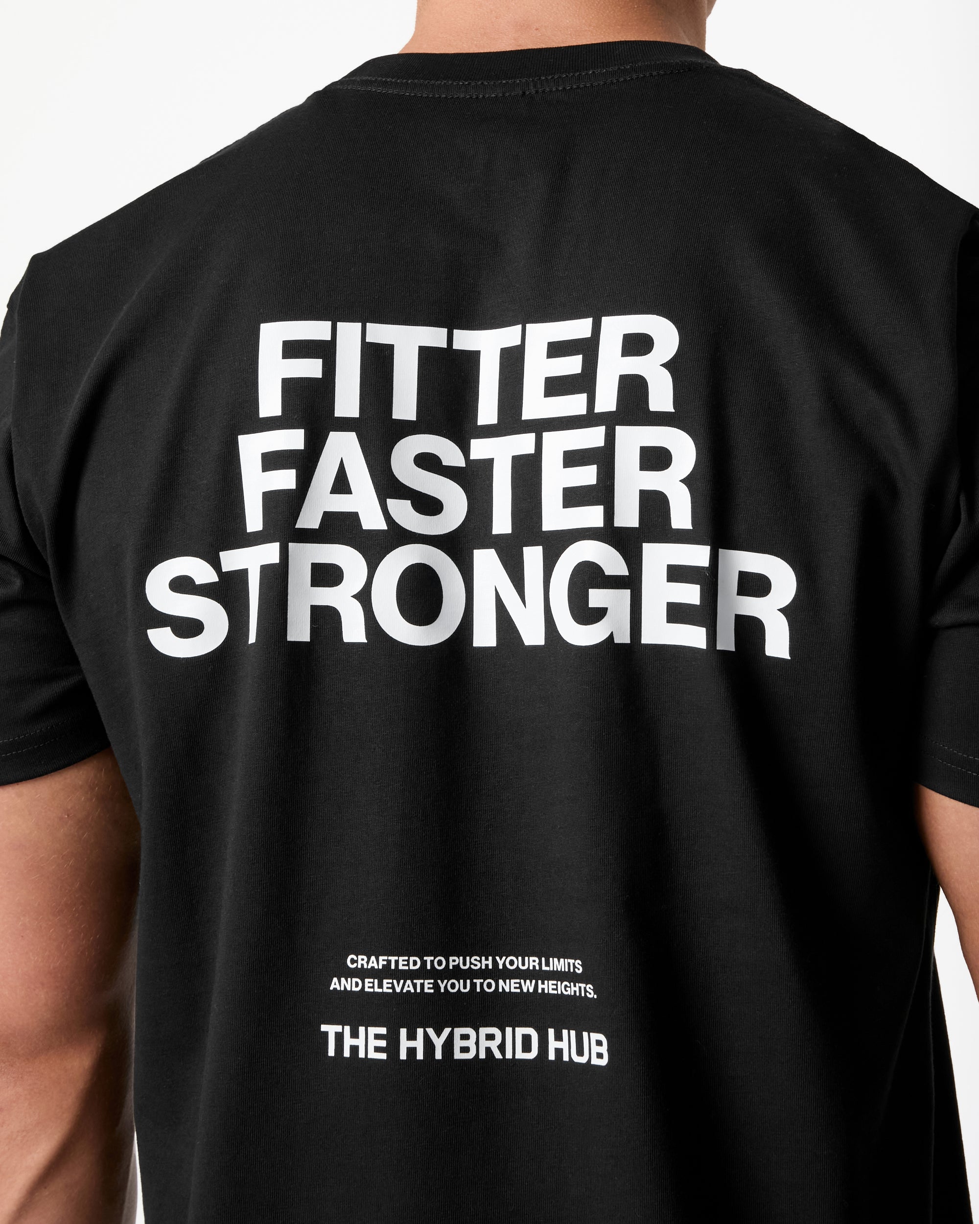Black t-shirt with 'Fitter Faster Stronger' text on the back, brand 'The Hybrid Hub' visible.