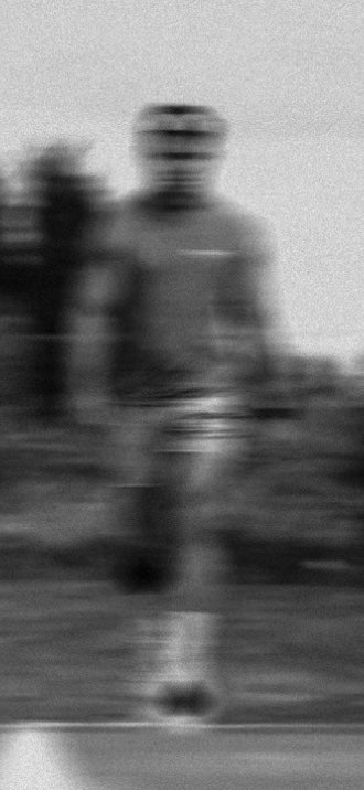 Person walking on a path with trees in the background