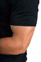 Close-up of a person wearing a black t-shirt on a white background